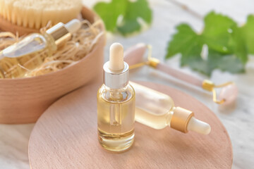 Board with bottles of grape seed oil on table