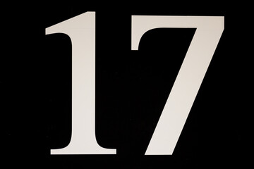 High contrast black and white sign with the number seventeen - 17