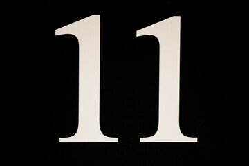 High contrast black and white sign with the number eleven - 11