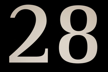 High contrast black and white sign with the number twenty-eight - 28