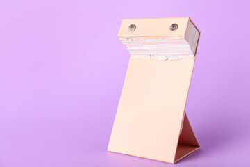 Tear-off calendar at the end of the year on color background