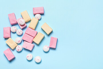 Tasty chewing gums on color background