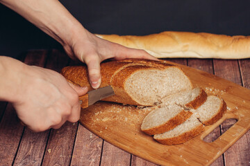cutting a fresh loaf on a cutting board crispy bread kitchen meal