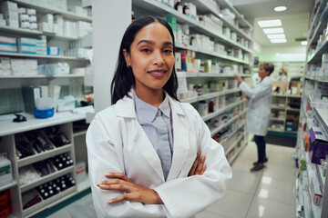 Portrait of young african american pharmacist standing between aisle in chemist - obrazy, fototapety, plakaty