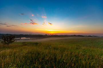Rural landscape with clouds at sunset 