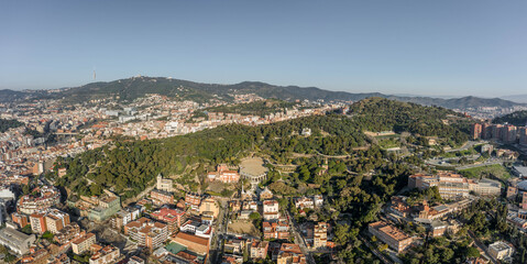 Fototapeta na wymiar Aerial panorama drones shot of park on hill outside Barcelona city in Spain winter morning