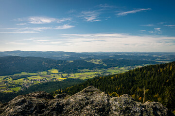 Fototapeta na wymiar View at a mountain over the bavarian forest in the summer with clouds on the sky