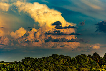Fototapeta na wymiar Thunderstorm clouds over a rural landscape at sunset