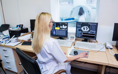 Radiologist in the control room of computed tomography at hospital