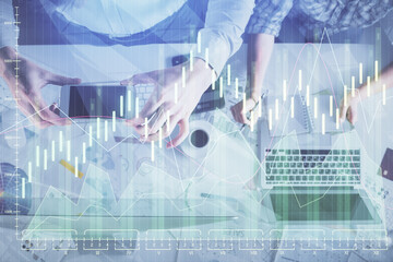 Double exposure of man and woman working together and financial chart hologram drawing. market...