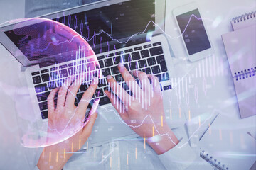 Double exposure of woman hands working on computer and forex chart hologram drawing. Top View. Financial analysis concept.