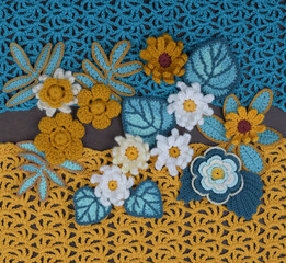Handmade texture with flowers, leaves, and crocheted background.