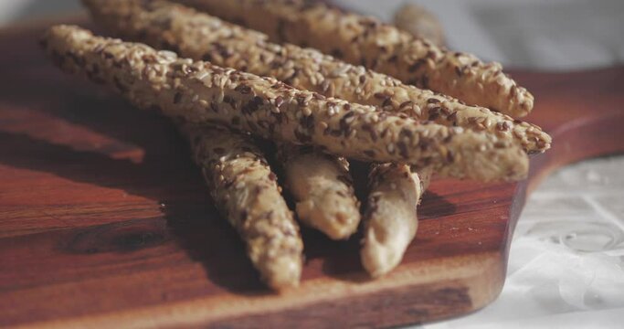 breadsticks with Cereal on a wooden cutting board, Grissini italian breadsticks