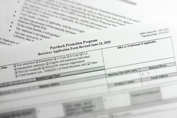 selective focus photo of paycheck protection program borrower application form revised. paycheck protection program new round