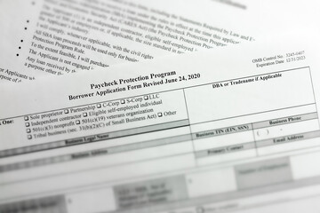 Obraz premium selective focus photo of paycheck protection program borrower application form revised. paycheck protection program new round