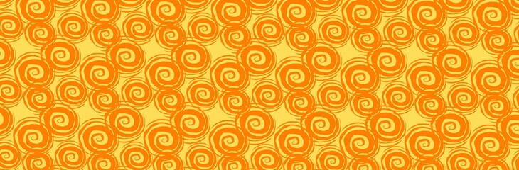 Orange spirals evenly spaced against a yellow background in a panoramic view