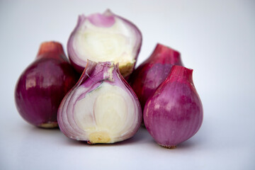 Red whole and sliced onions, isolated on white background
