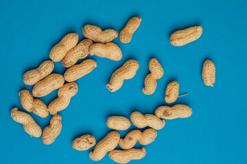 peanuts in shells on a blue background snack rest
