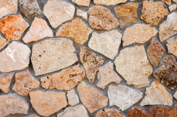 Decorative wall made of natural stone of various shapes and sizes. Interior background