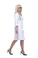 Fototapeta premium confident woman doctor striding forward. isolated on a white