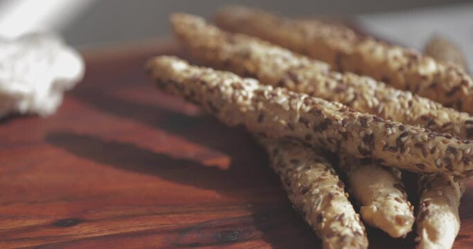 breadsticks with Cereal on a wooden cutting board, Grissini italian breadsticks