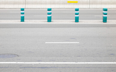 Four safety control plastic poles on highway.