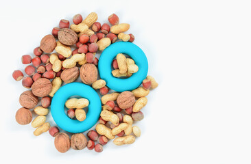 Mixture of nuts with simulator for hand by an expander. The concept of sports nutrition and diet for weight loss.