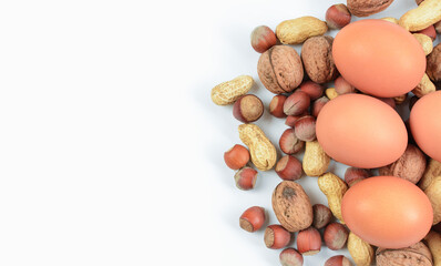 Blend of nuts with chicken eggs on white background. Concept of protein nutrition and diet for weight loss.
