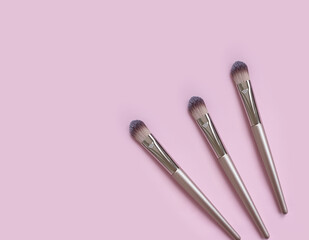 makeup brush on colored background