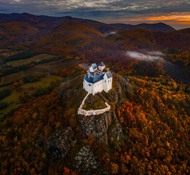 Fuzer, Hungary - Aerial view of the beautiful Castle of Fuzer with amazing colorful sunrise sky and clouds on an autumn morning. The castle has been located in the mountains of Zemplen