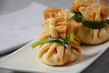 Chicken-Filled Crepe Party Purses. Pancakes rolled into a bag and stuffed with chicken meat