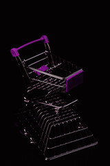 Shopping cart standing on shopping basket. Modern retail and commerce minimal concept with purple accent colour