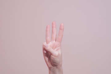 Hand showing number three count gesture. Closeup, copy space. Hand signs communication concept
