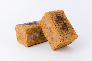 Two meju closeup on white background. Korean traditional fermented soybean food.