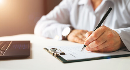 Businesswoman signing a document. Panoramic banner with  copy space.