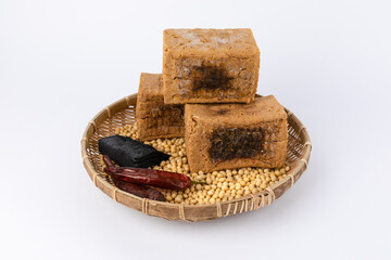 Meju, beans, dried chilli, charcoal set and white background. Korean traditional fermented soybean food.