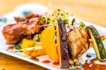 Pork ribs with grilled vegetables. Food styling for street food. Closeup.