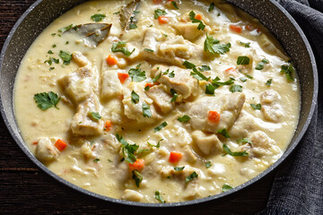 poached cod fish in milk base sauce