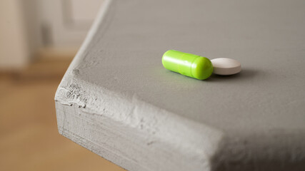 White and green pill on the table