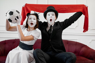 Two mime artists, football fans parody