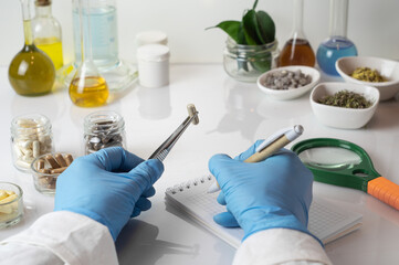 Doctor or pharmacist examining a medical capsule with a magnifying glass