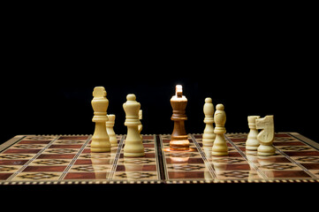 Chess pieces on the board. The king is surrounded by pieces of a different color.