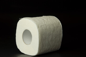 Roll of toilet paper on a black background.