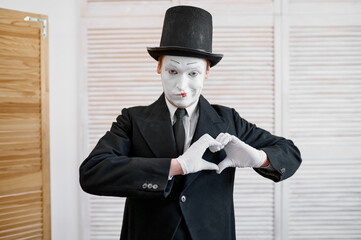 Male mime artist, love heart gesture, parody