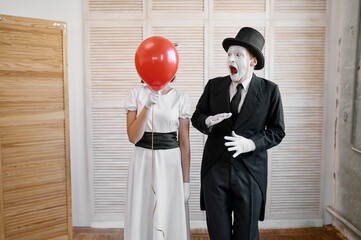 Two mime artists with air balloon, comedy parody