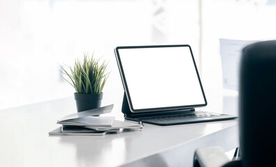 office desk with mock-up computer devices, supplies and decorations on white table.