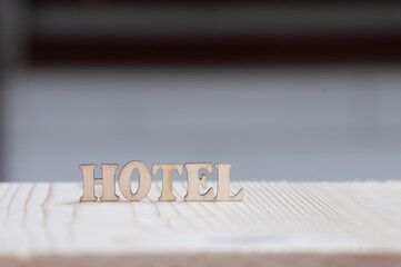 HOTEL written with wooden letters decorated on wooden board.