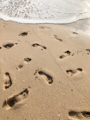 foot prints on the sandy beach in summer