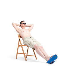 Fototapeta na wymiar Happy man in sunglasses, shorts and flip flops sits relaxed sunbathing on a chair, isolated on white background