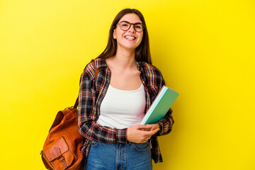 Young student woman isolated on yellow background laughing and having fun.
